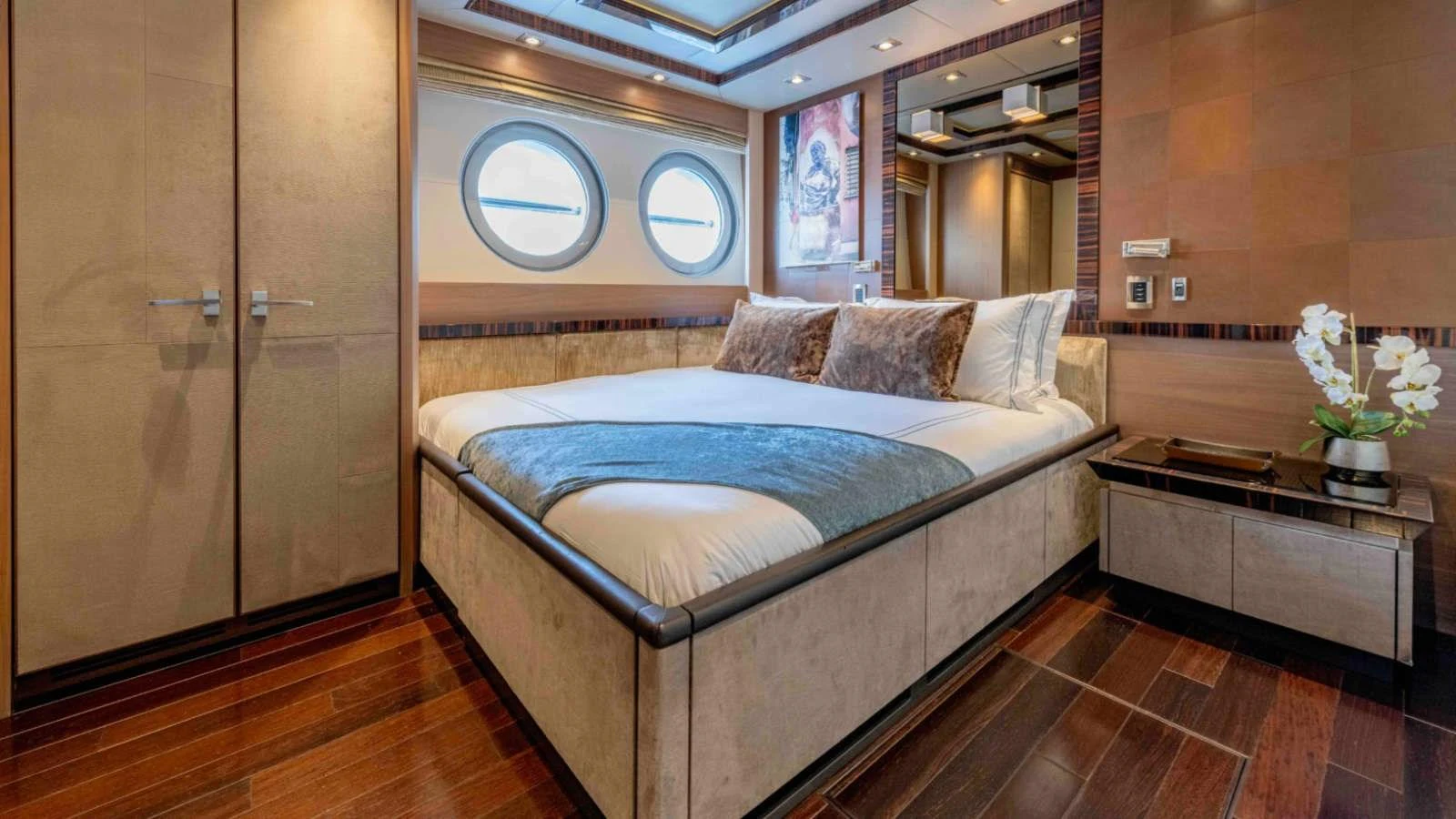The stateroom features a luxurious bed with elegant decor and ample natural light. aboard PALMER JOHNSON 150 Yacht for Sale