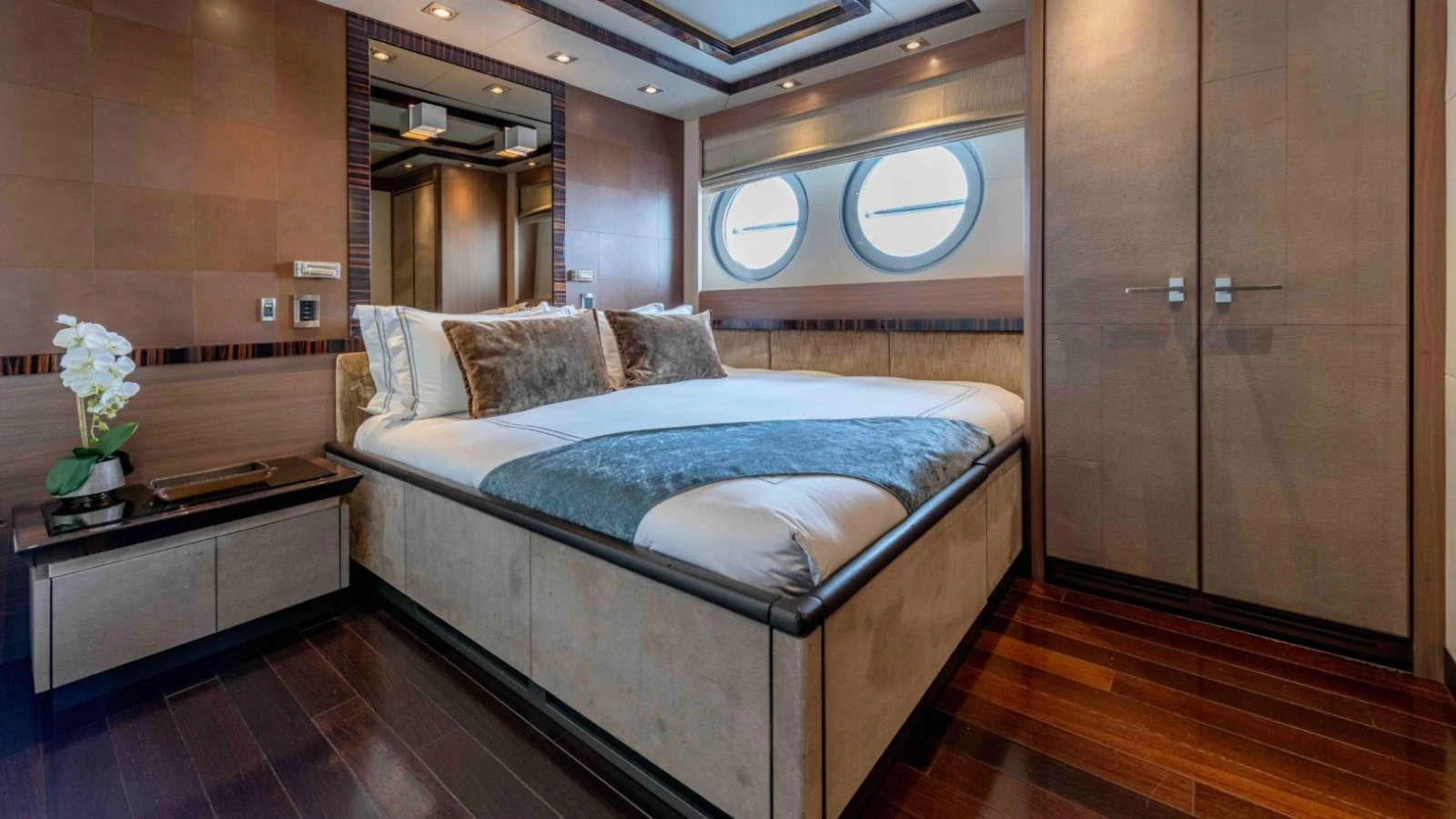 The stateroom features a luxurious bed with plush pillows and elegant decor. aboard PALMER JOHNSON 150 Yacht for Sale