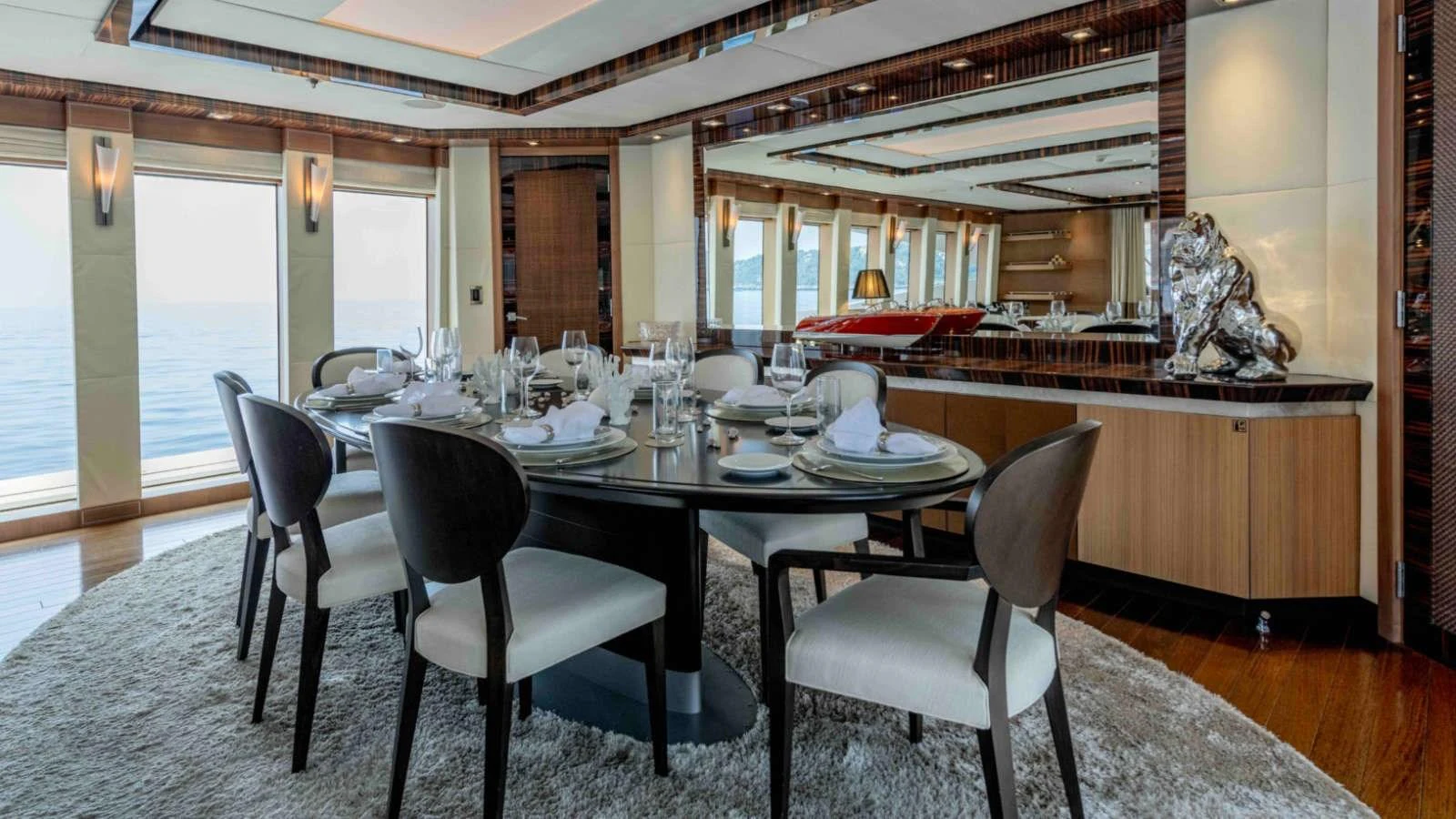 The yacht's dining area features elegant table settings and panoramic ocean views. aboard PALMER JOHNSON 150 Yacht for Sale