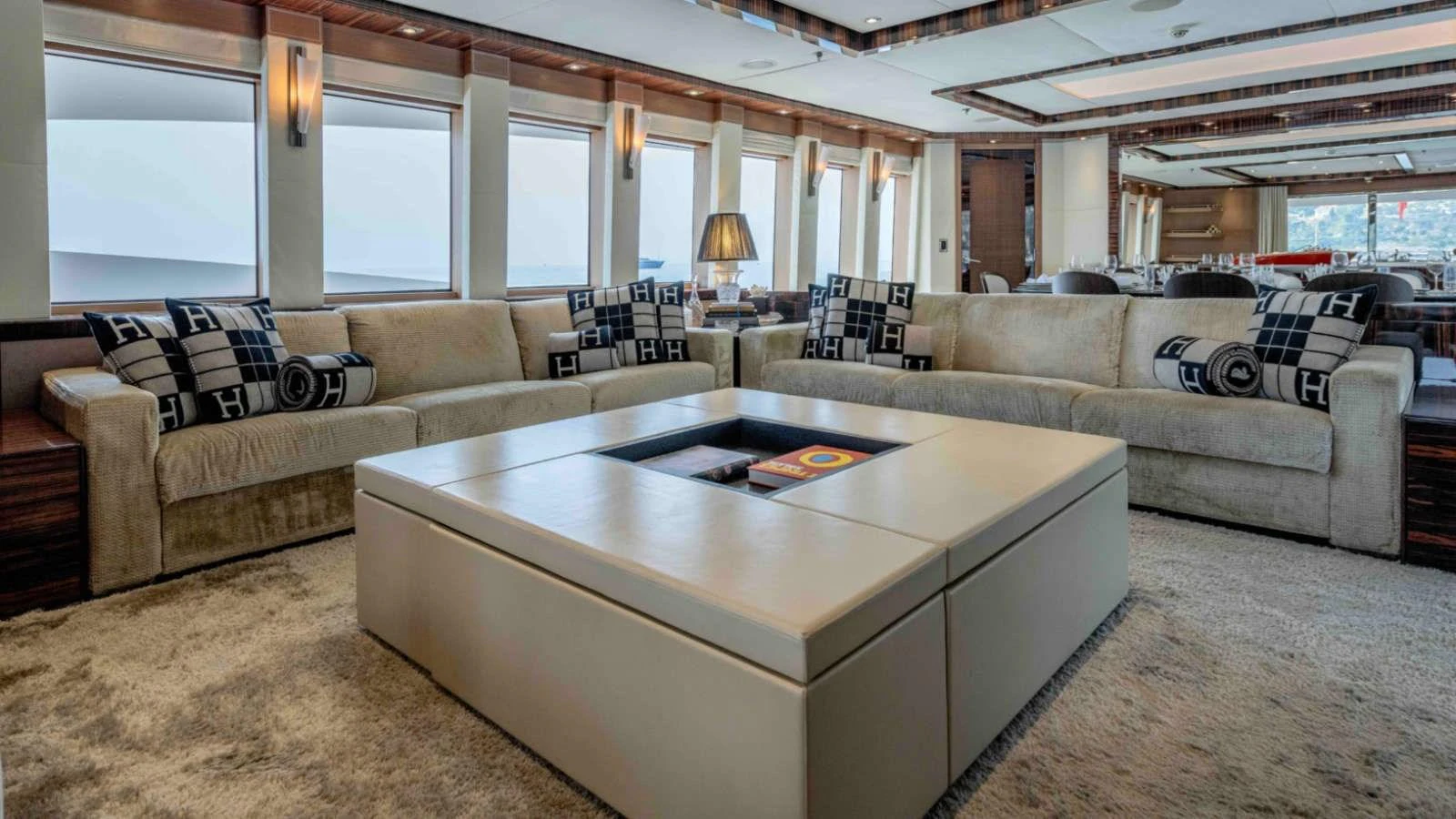 The salon features plush seating and a modern coffee table, creating a luxurious and inviting atmosphere. aboard PALMER JOHNSON 150 Yacht for Sale