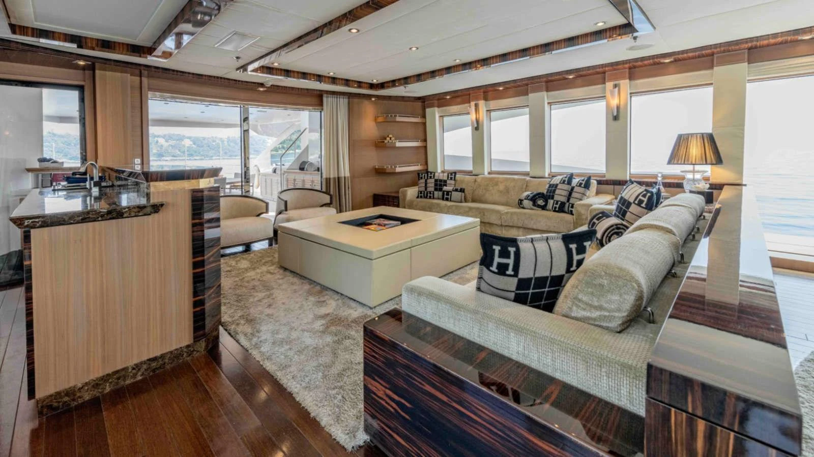 The salon features luxurious seating with panoramic windows offering stunning sea views. aboard PALMER JOHNSON 150 Yacht for Sale