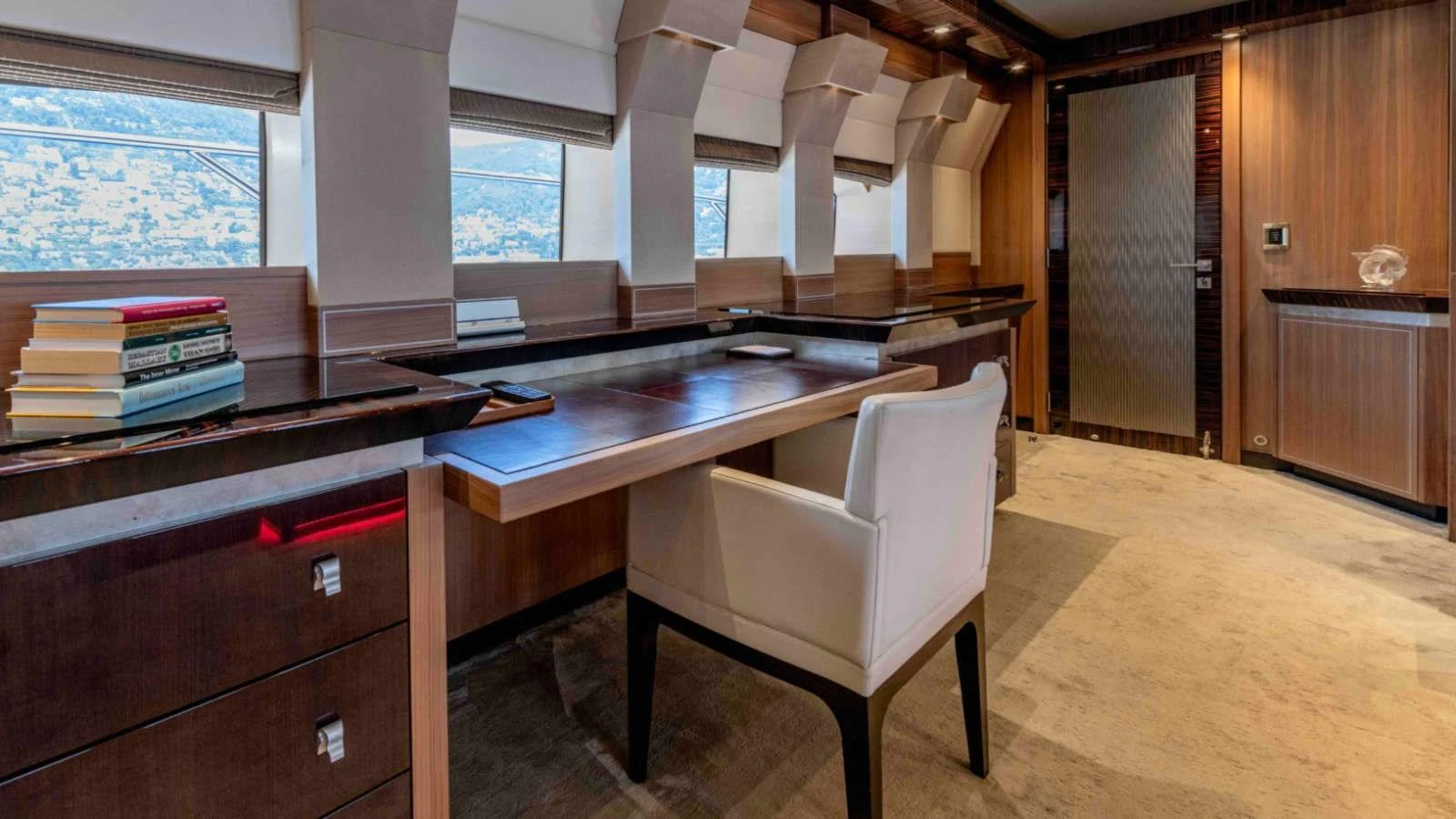 The yacht's office features a sleek desk, comfortable chair, and ample natural light through large windows. aboard PALMER JOHNSON 150 Yacht for Sale