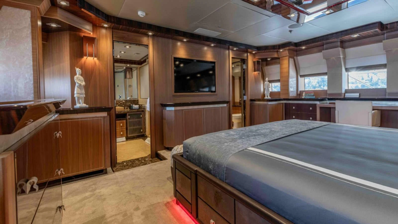 The master stateroom features luxurious wood finishes and modern amenities for ultimate comfort. aboard PALMER JOHNSON 150 Yacht for Sale