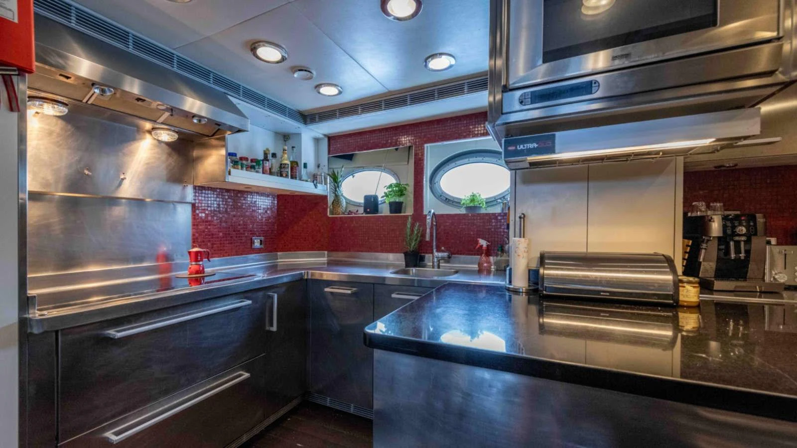 The yacht's galley features modern stainless steel appliances and a sleek, contemporary design. aboard PALMER JOHNSON 150 Yacht for Sale