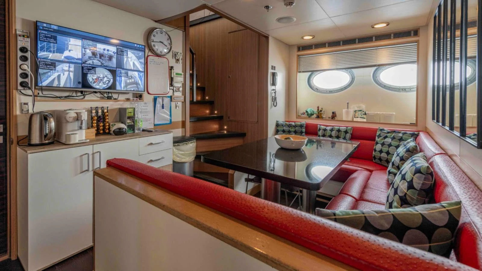 The crew mess area features a comfortable seating arrangement and modern amenities. aboard PALMER JOHNSON 150 Yacht for Sale