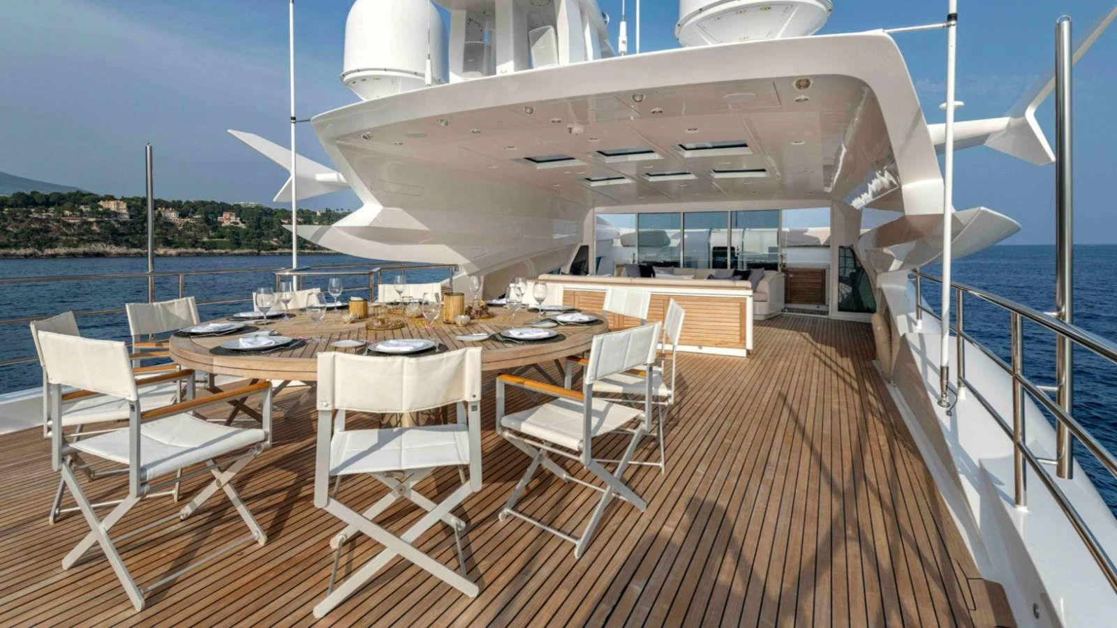 The aft deck features a spacious dining area with elegant seating and a stunning ocean view. aboard PALMER JOHNSON 150 Yacht for Sale
