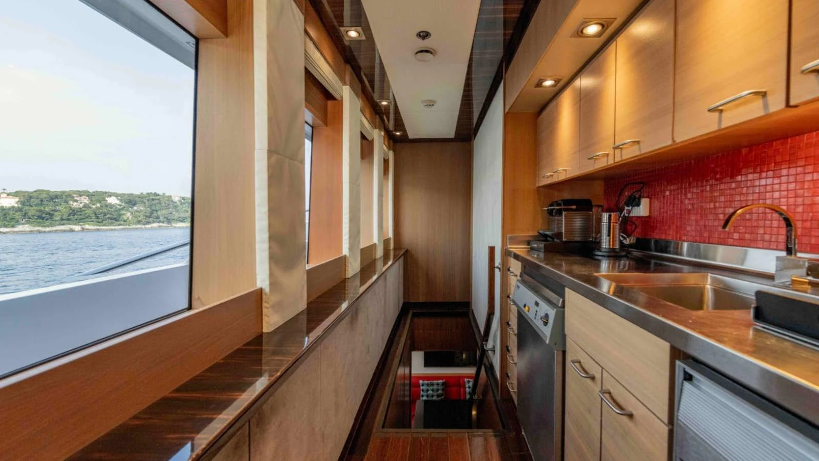The yacht's galley features modern appliances and a sleek design with ample natural light. aboard PALMER JOHNSON 150 Yacht for Sale