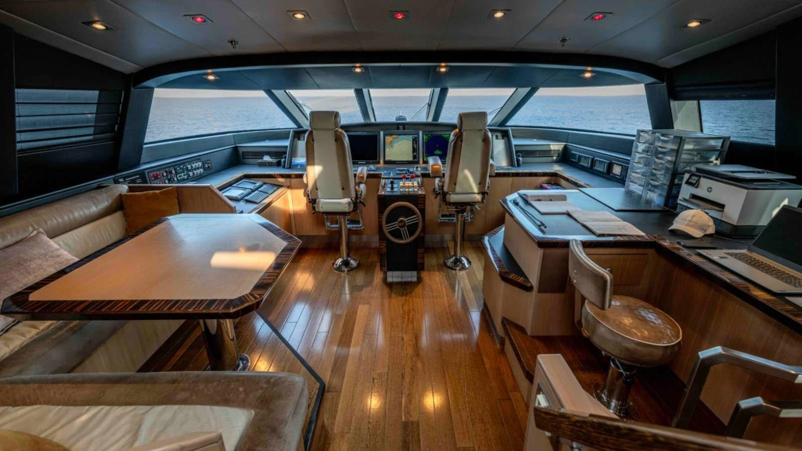 The helm of this yacht features state-of-the-art navigation equipment and luxurious seating with a panoramic view of the sea. aboard PALMER JOHNSON 150 Yacht for Sale