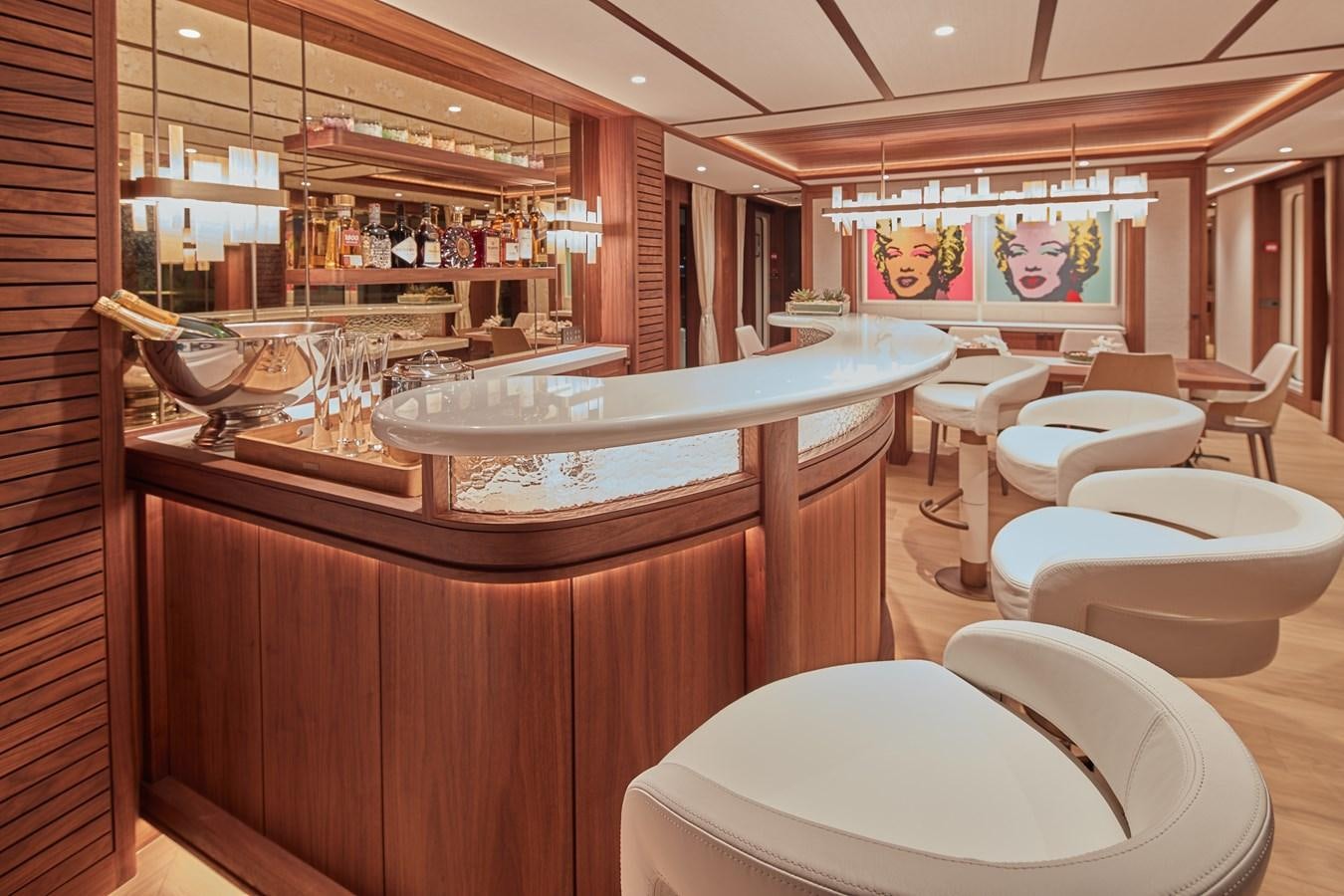 a room with a table chairs and a large window aboard SOLEMATES V Yacht for Sale