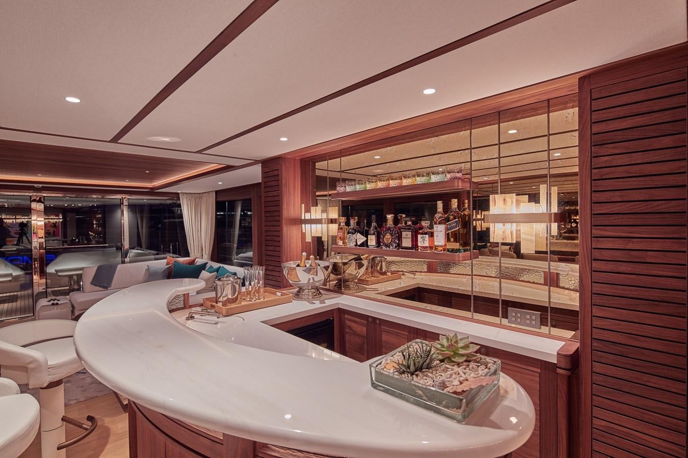 a modern looking kitchen with a large glass wall aboard SOLEMATES V Yacht for Sale
