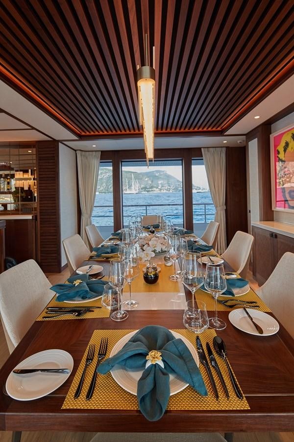 a table with plates and glasses aboard SOLEMATES V Yacht for Sale