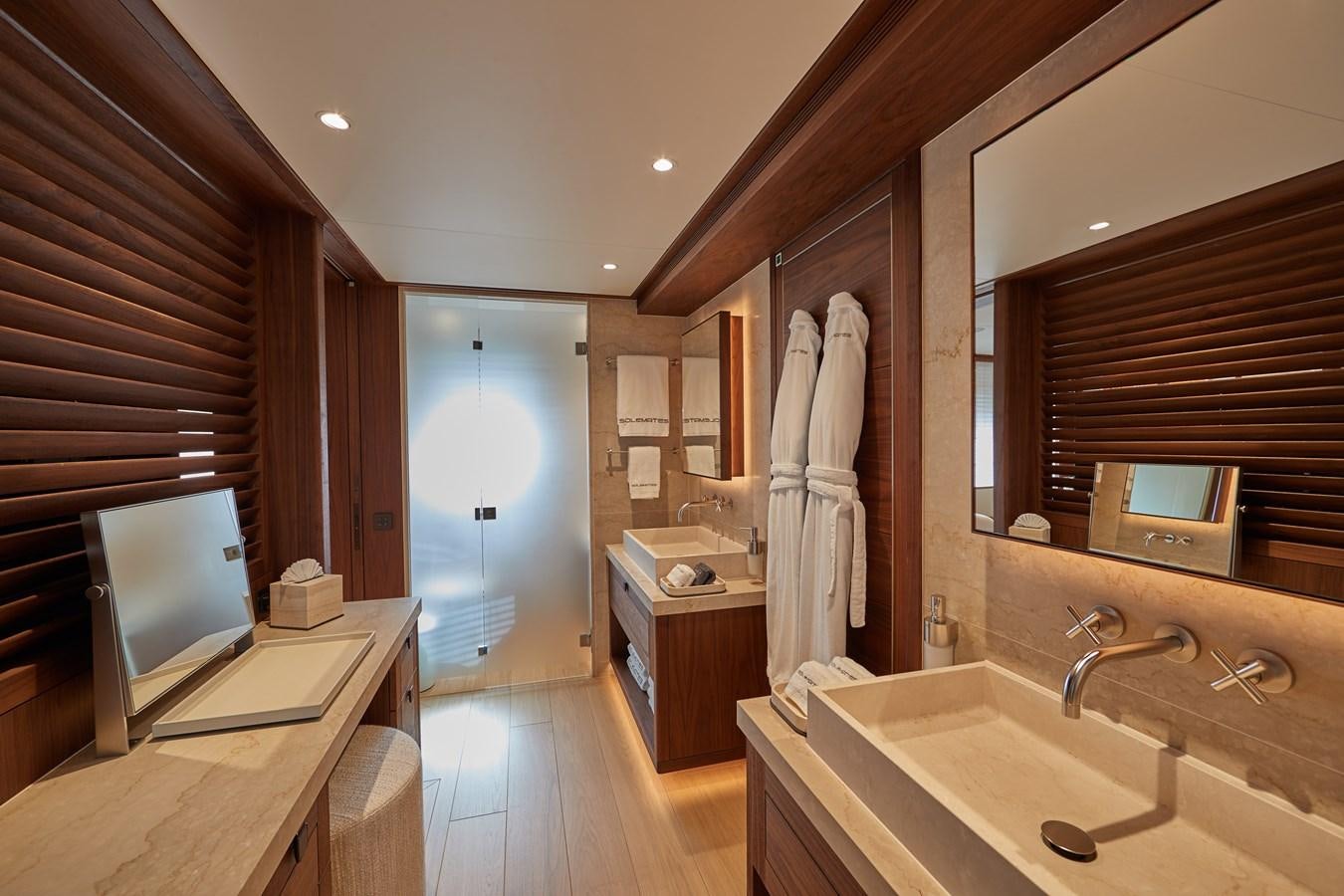 a bathroom with a sink and a tv aboard SOLEMATES V Yacht for Sale