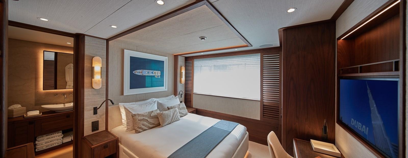 a room with a bed and a television aboard SOLEMATES V Yacht for Sale