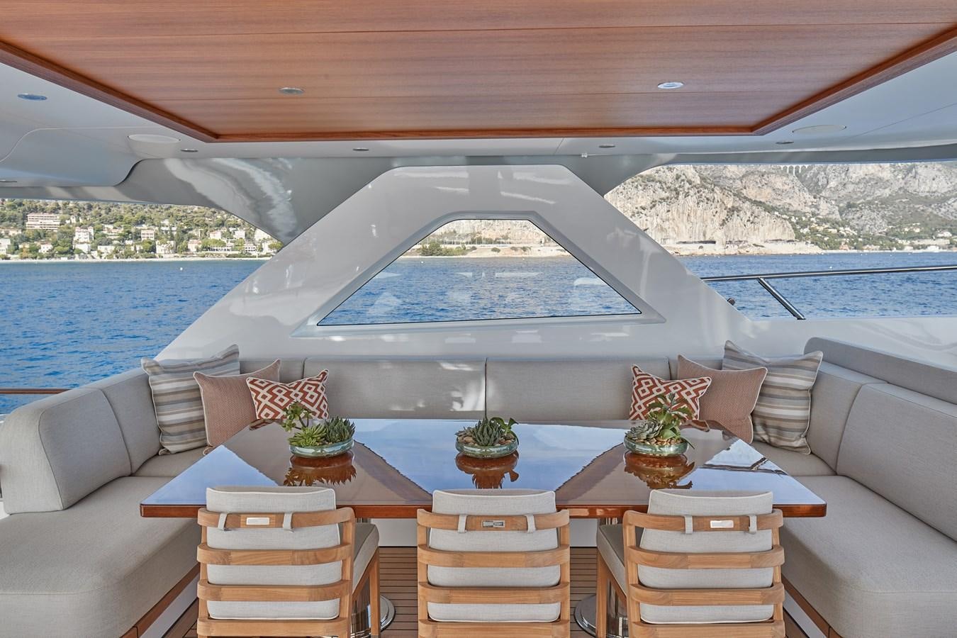 a table with chairs and a white umbrella on it aboard SOLEMATES V Yacht for Sale