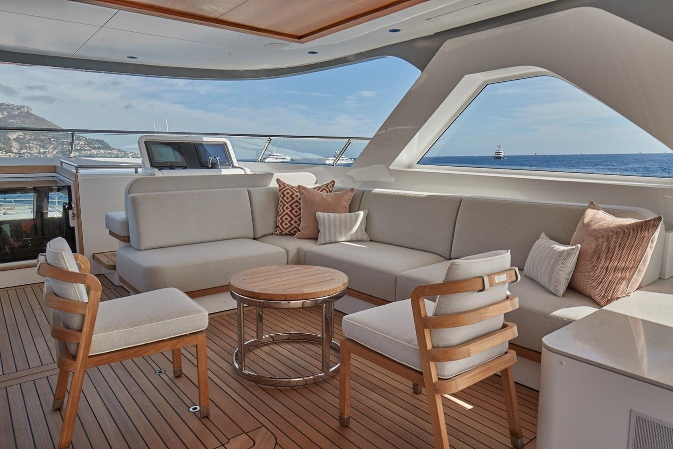 a living room with a large white sofa and a large window aboard SOLEMATES V Yacht for Sale