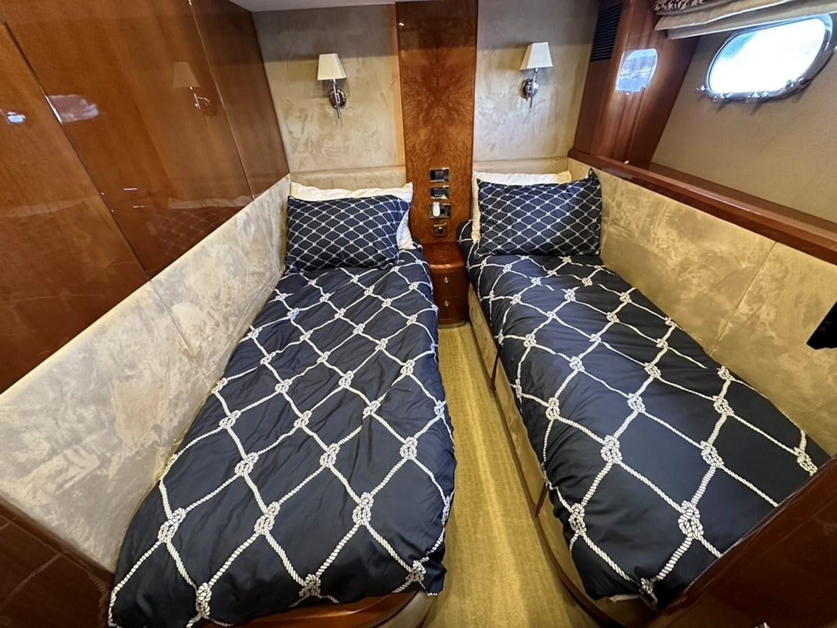 a room with a bed and a chair aboard OCARALIA Yacht for Sale