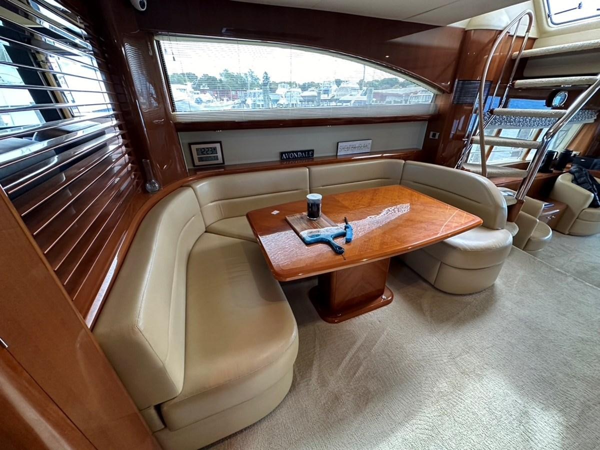 a couch and coffee table in a train car aboard OCARALIA Yacht for Sale