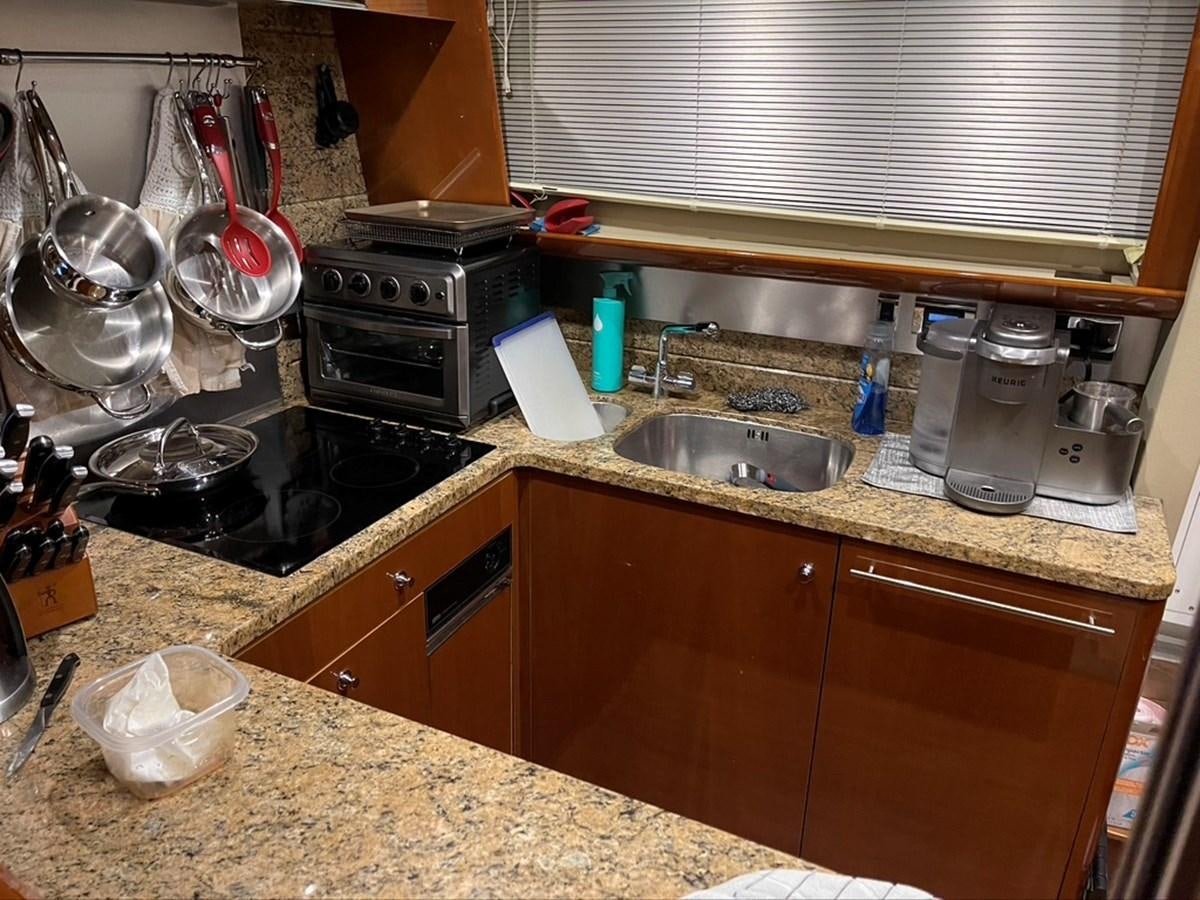 a kitchen with a sink and stove aboard OCARALIA Yacht for Sale