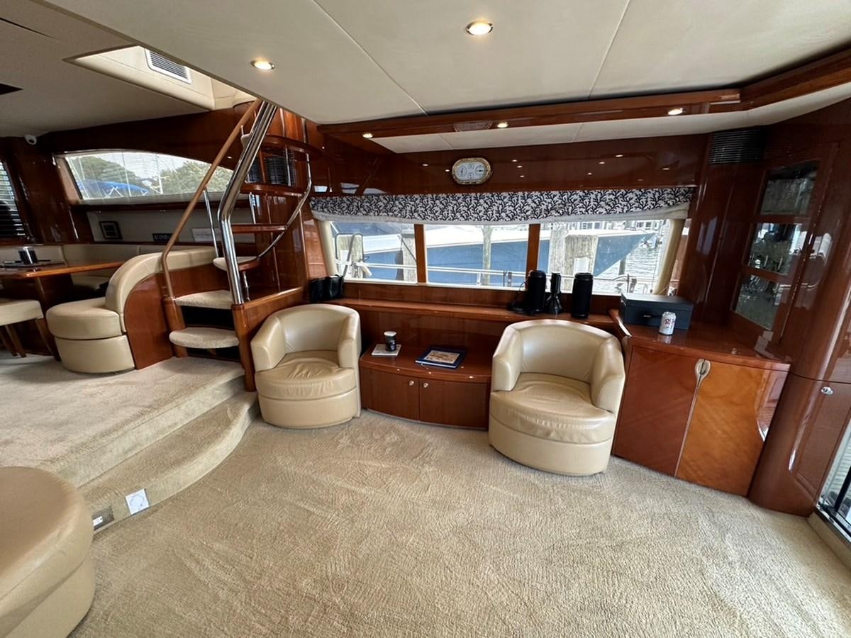a room with a large window and a large wood cabinet with a large mirror and a large window aboard OCARALIA Yacht for Sale