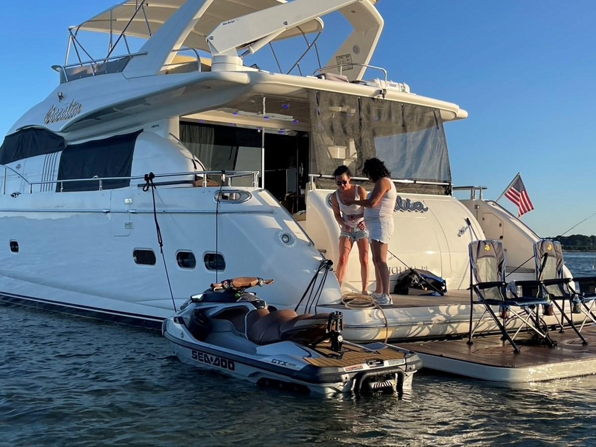 a couple of people standing on a boat in the water aboard OCARALIA Yacht for Sale