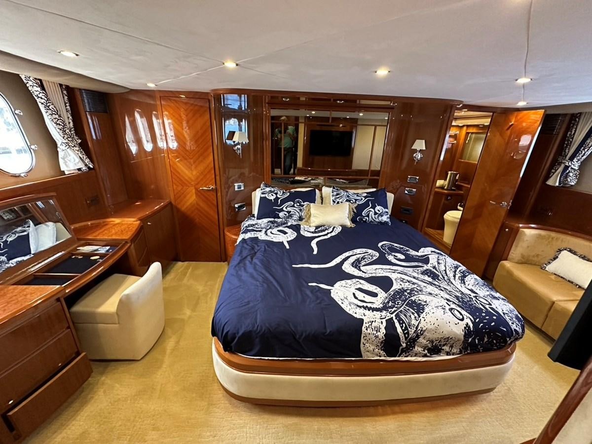 a bedroom with a bed and desk aboard OCARALIA Yacht for Sale