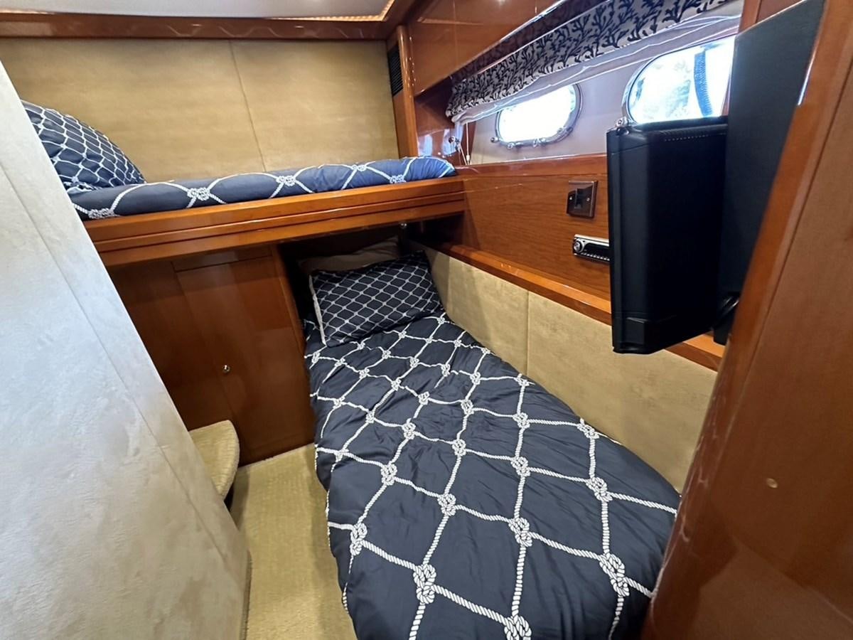 a bed with a black and white blanket aboard OCARALIA Yacht for Sale