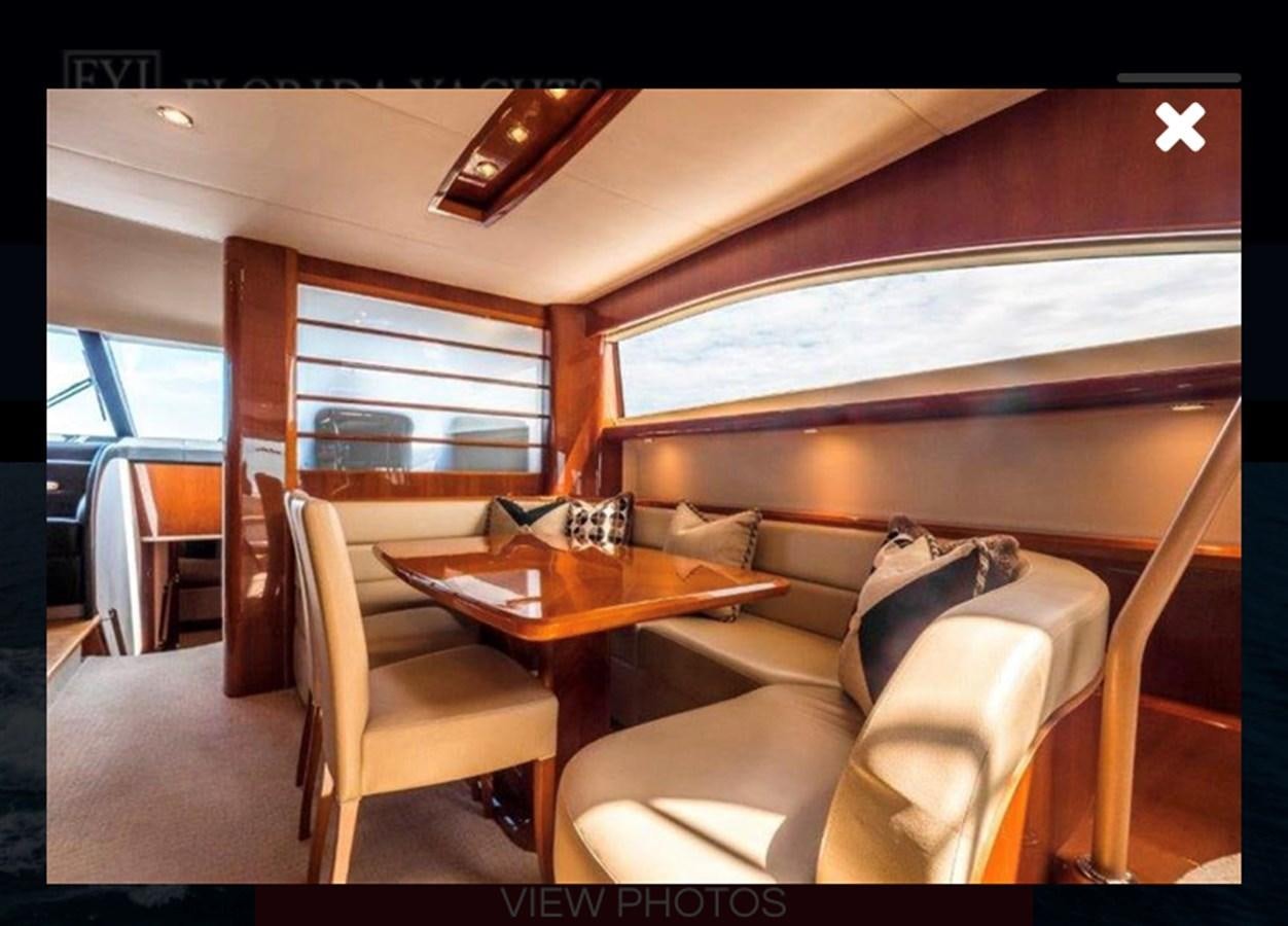 a room with a table and chairs aboard OCARALIA Yacht for Sale