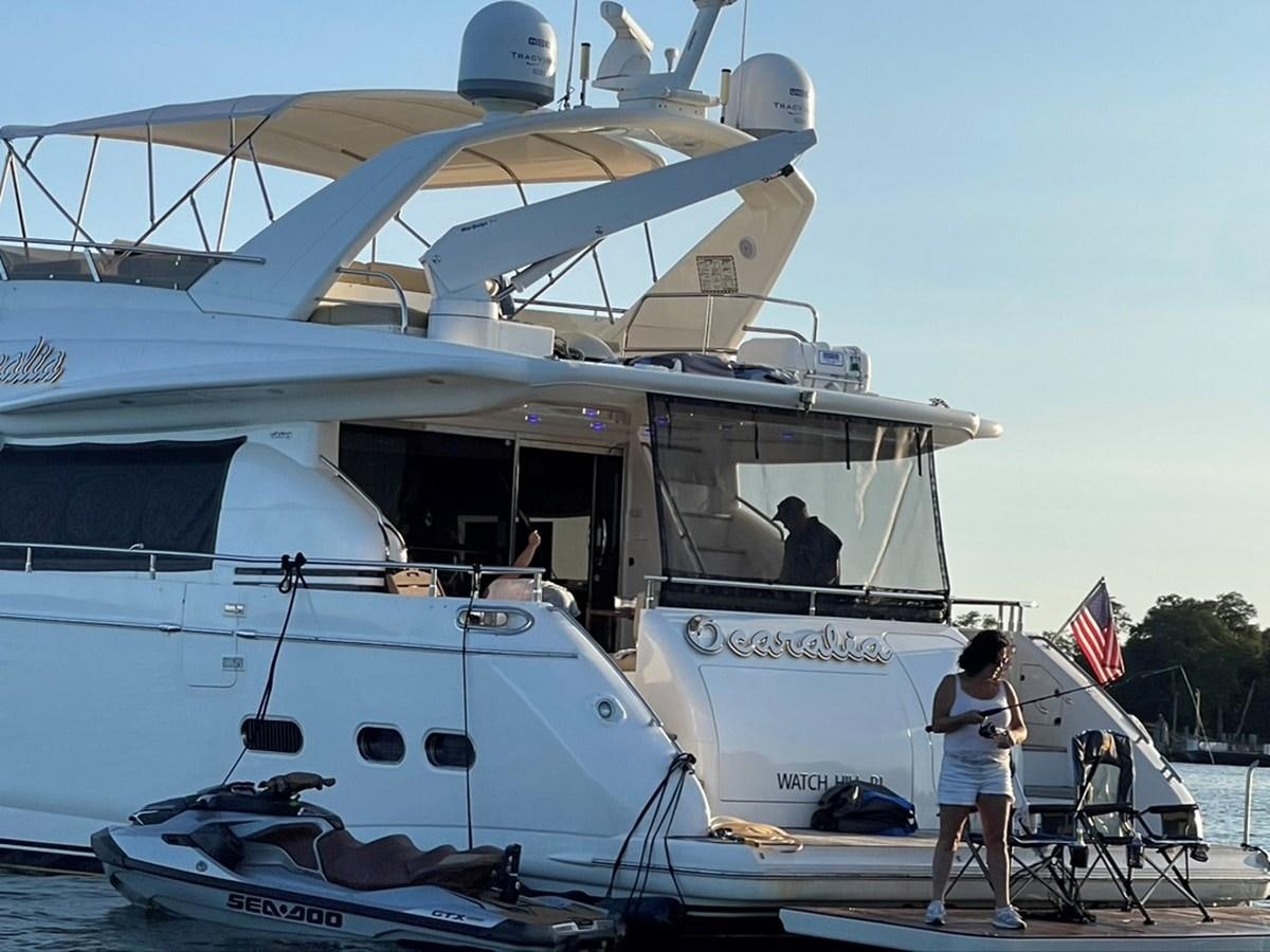 a person standing next to a boat aboard OCARALIA Yacht for Sale