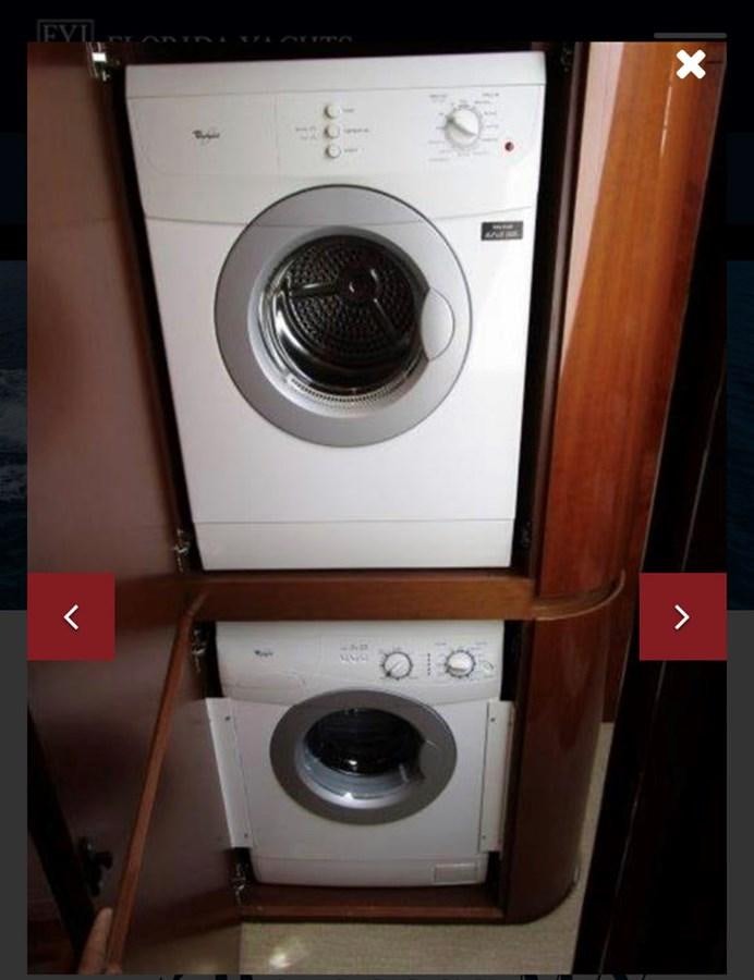 a washing machine in a closet aboard OCARALIA Yacht for Sale