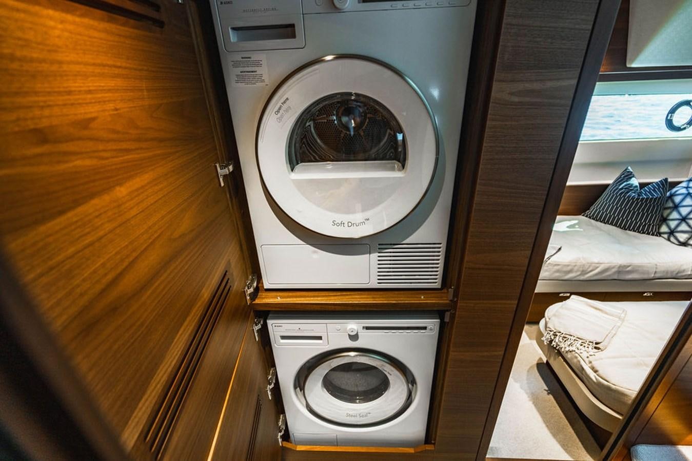 a washing machine in a room aboard CHAOS Yacht for Sale