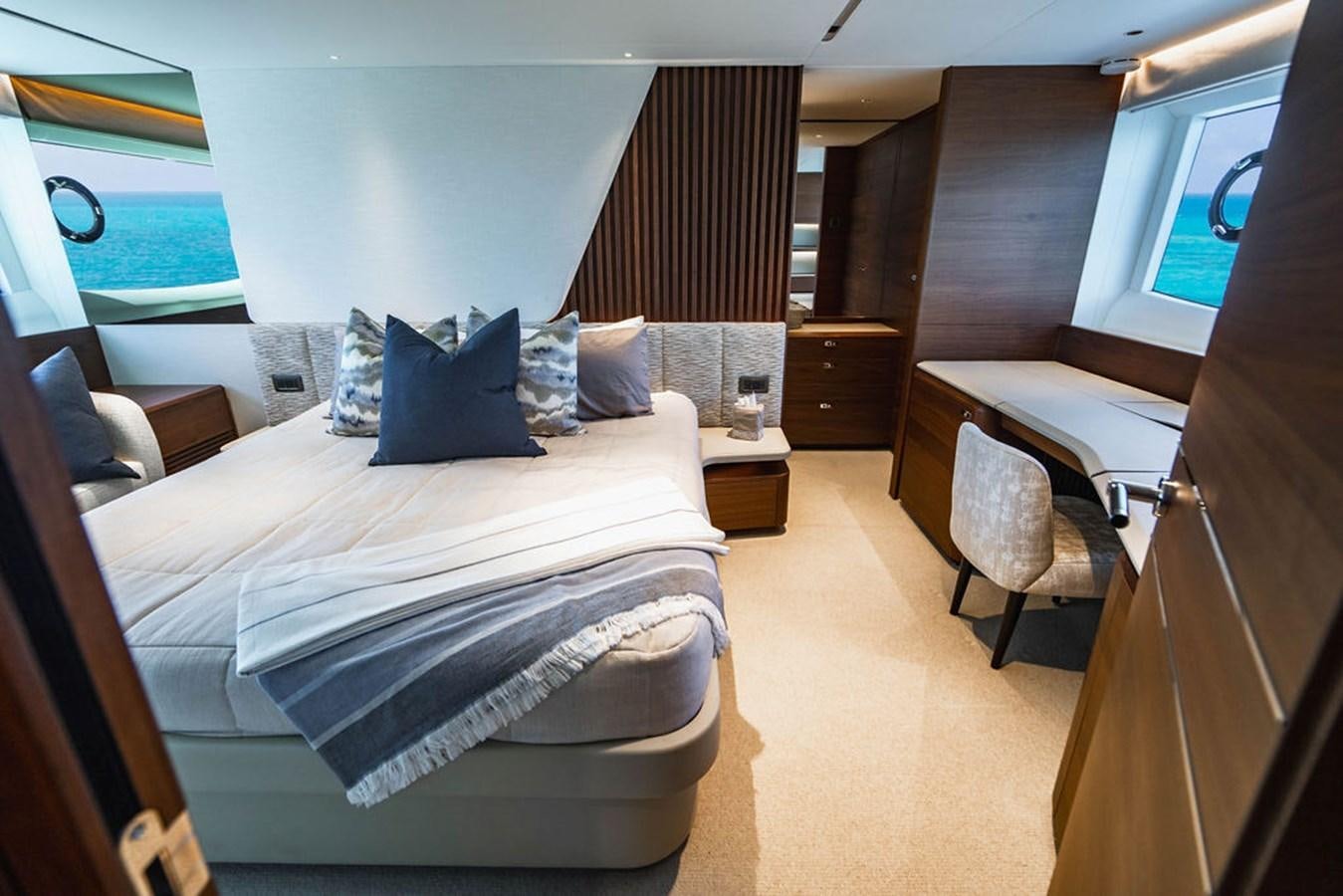 a room with a bed and a desk aboard CHAOS Yacht for Sale