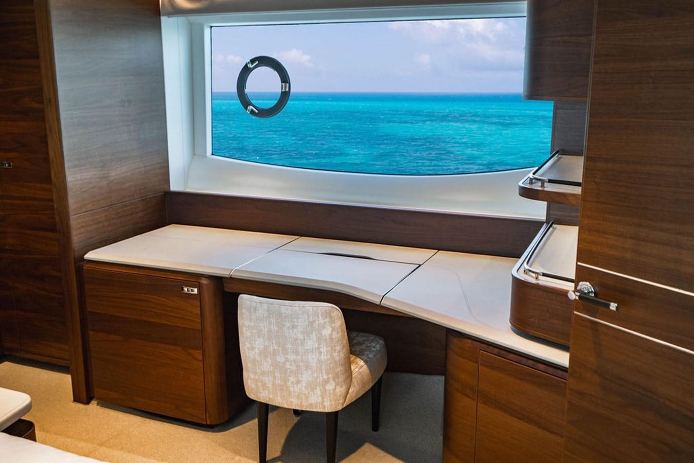 a desk with a chair and a window aboard CHAOS Yacht for Sale