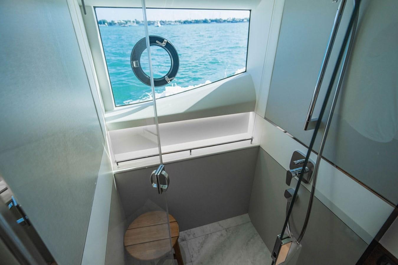 a toilet with a rope attached to the seat aboard CHAOS Yacht for Sale