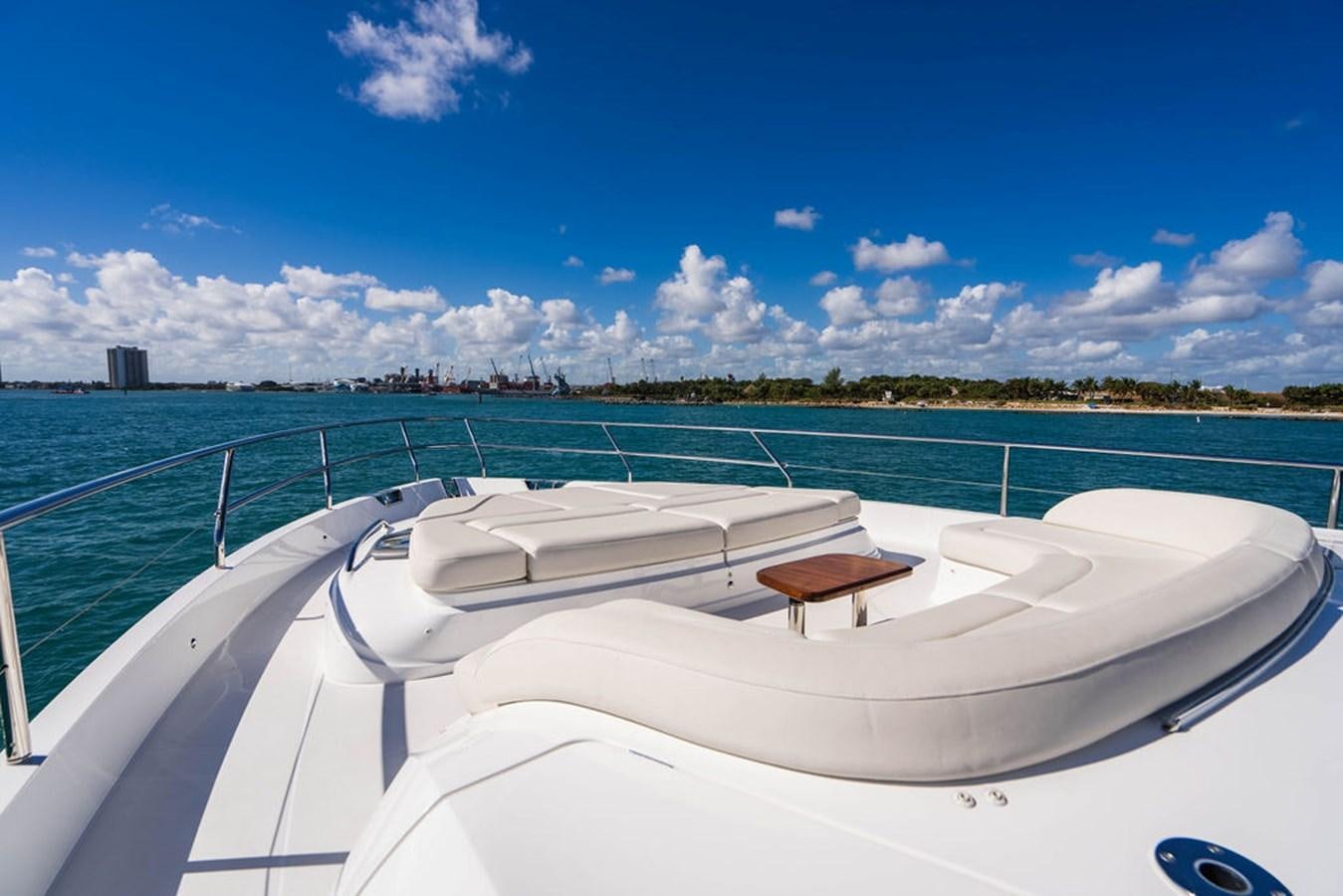 a white boat on a blue water aboard CHAOS Yacht for Sale