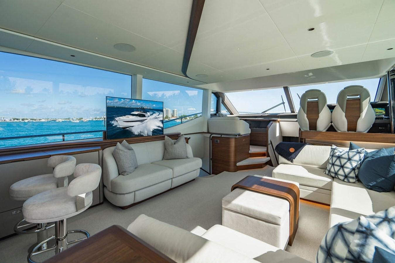a room with a couch and a tv on the wall aboard CHAOS Yacht for Sale