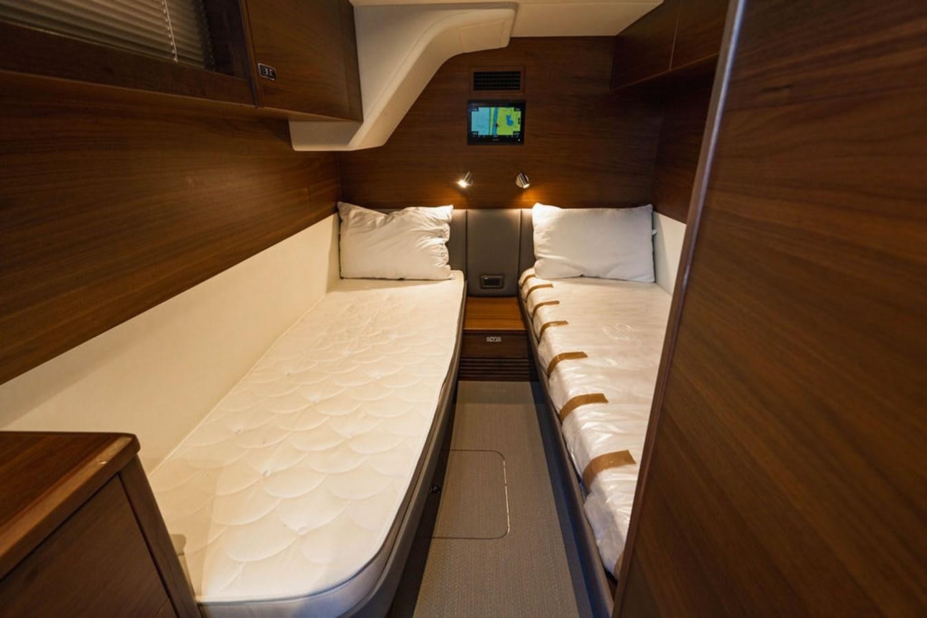a room with bunk beds aboard CHAOS Yacht for Sale