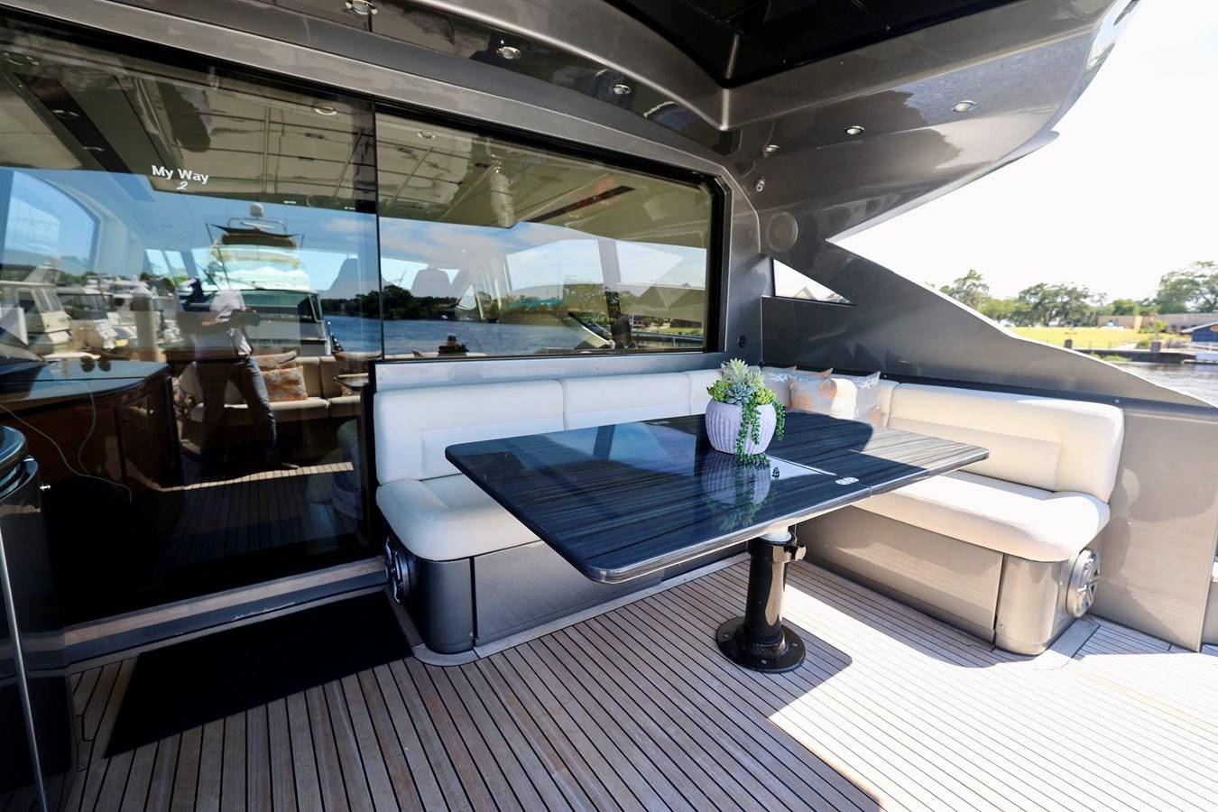 a room with a table and couch aboard MY WAY Yacht for Sale