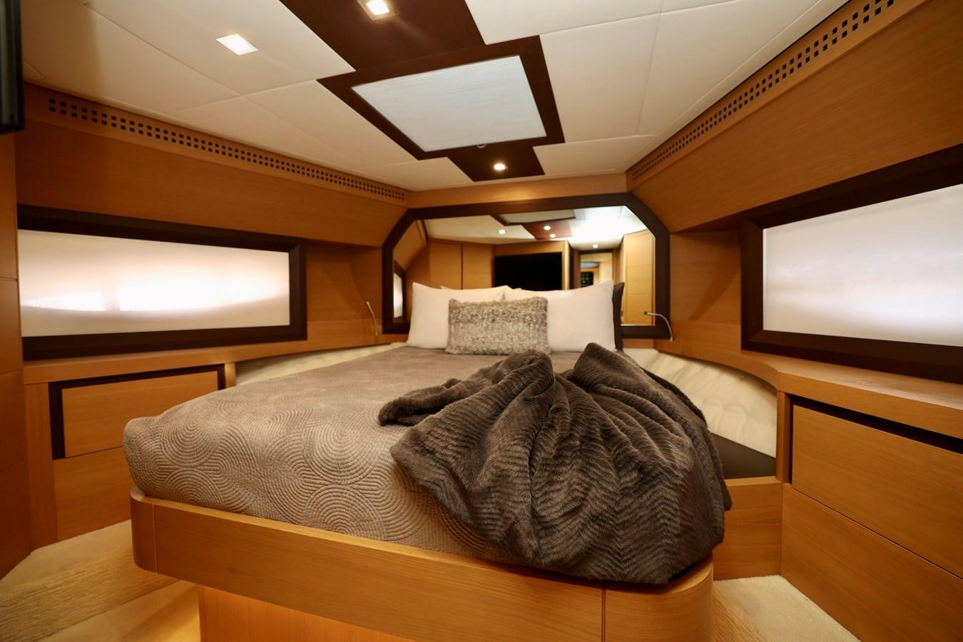 a bed with a television on the wall aboard MY WAY Yacht for Sale