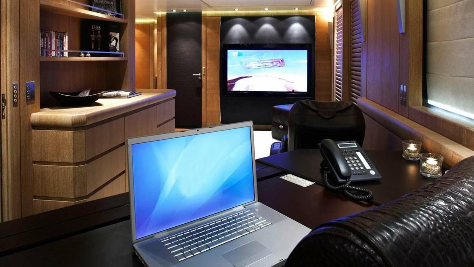 a laptop on a desk aboard NINO Yacht for Sale