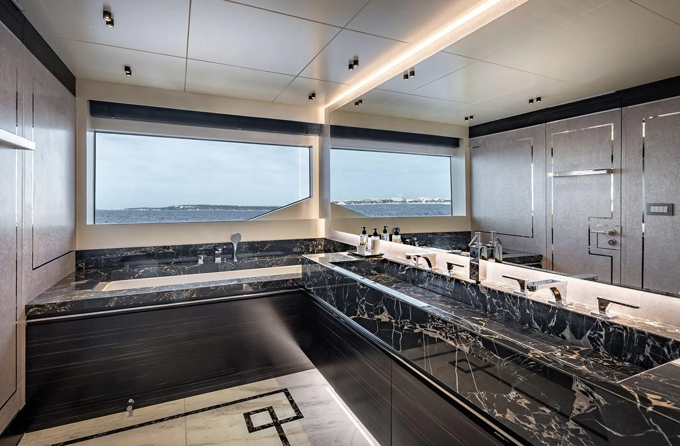 The luxurious bathroom features sleek black marble countertops and expansive ocean views. aboard 40MXP Yacht for Sale