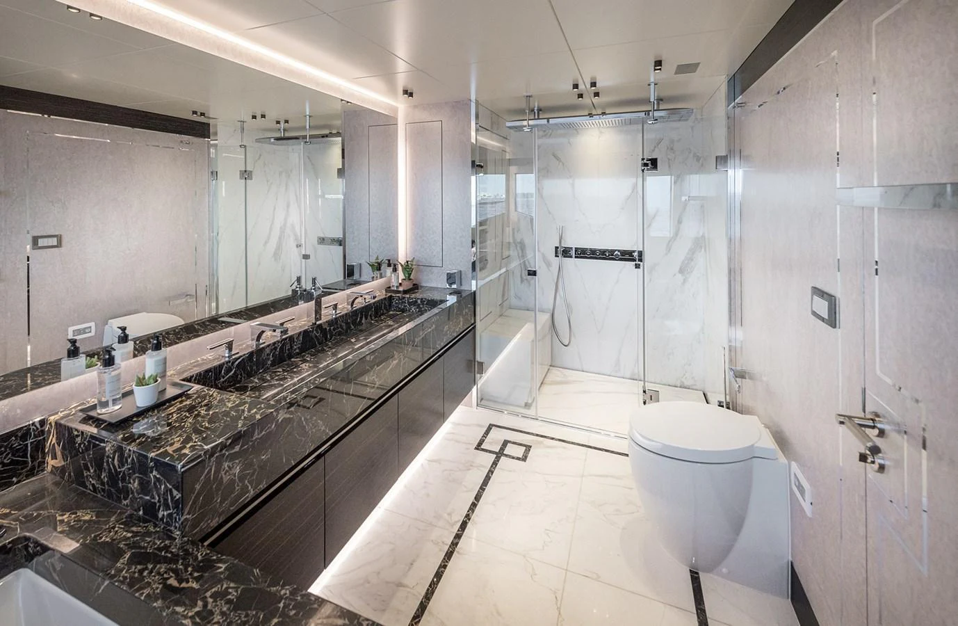 The bathroom features luxurious marble finishes and modern fixtures. aboard 40MXP Yacht for Sale