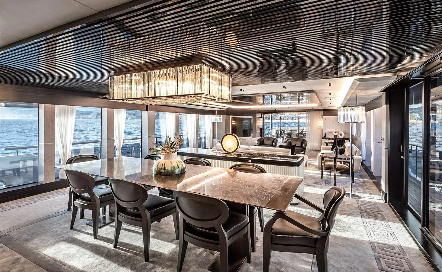 The yacht's dining area features an elegant table with plush seating and panoramic ocean views. aboard 40MXP Yacht for Sale