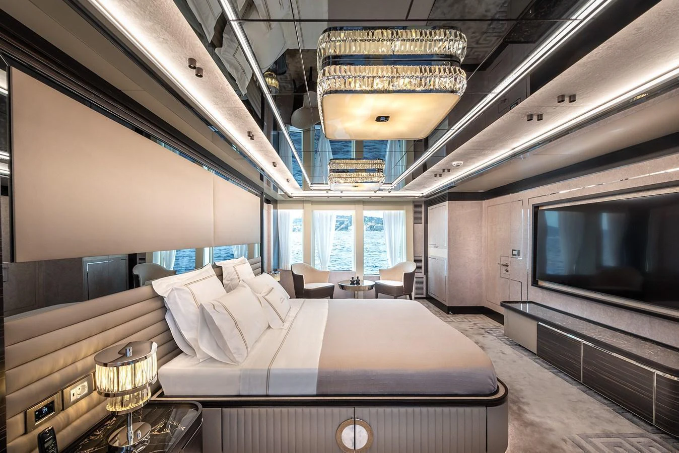 The master stateroom features a luxurious bed, elegant lighting, and a spacious layout with a large window view. aboard 40MXP Yacht for Sale