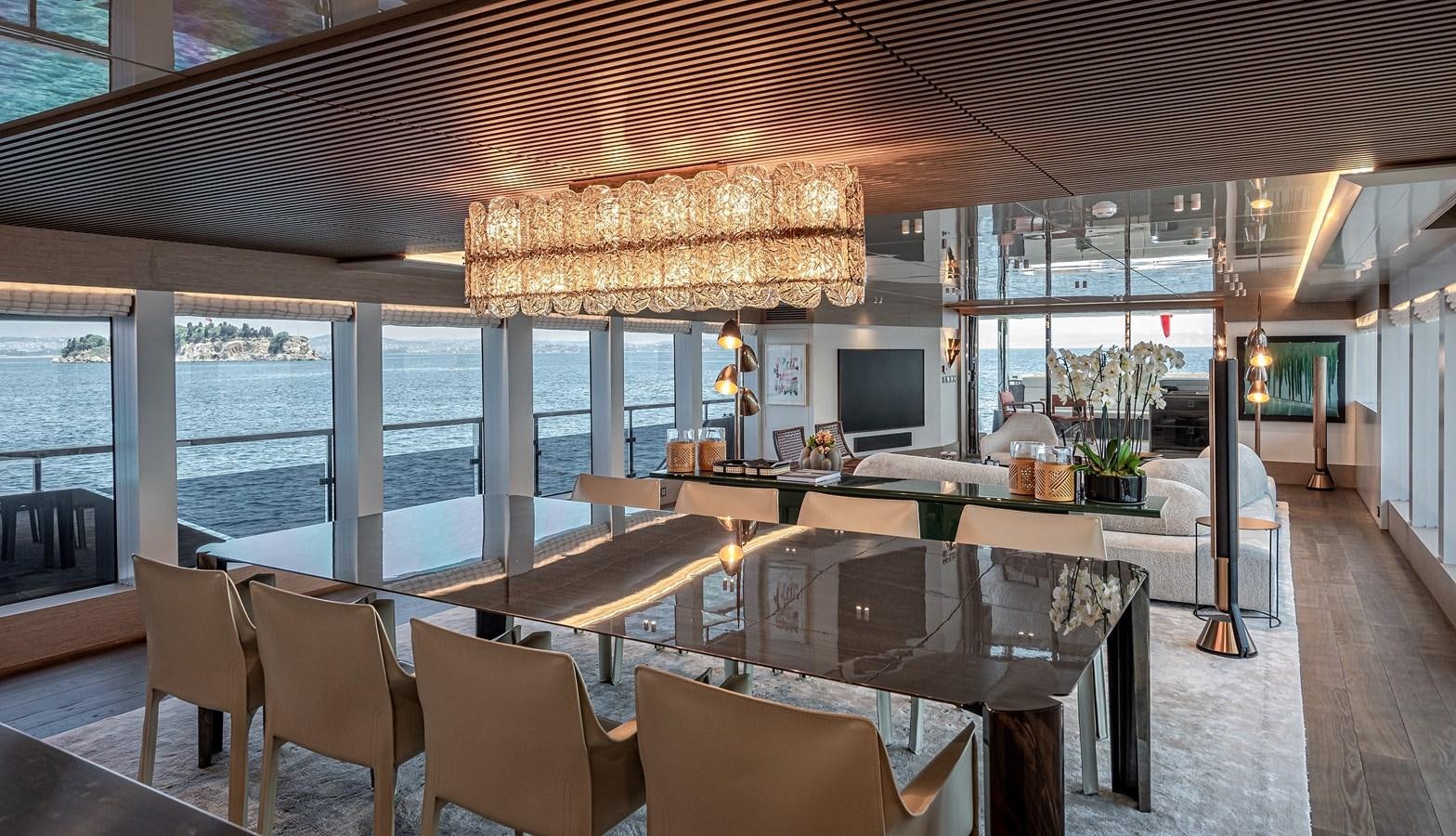a large room with a table and chairs aboard 37XP Yacht for Sale