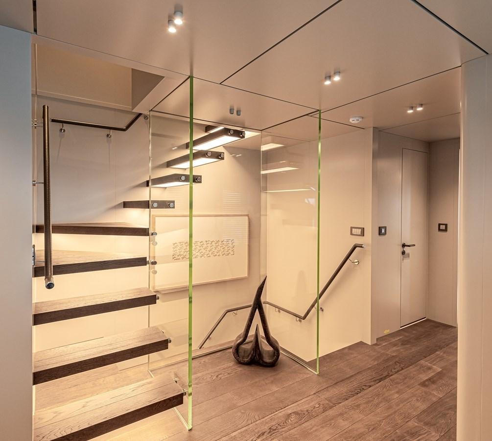 a room with a glass wall and a staircase aboard 37XP Yacht for Sale