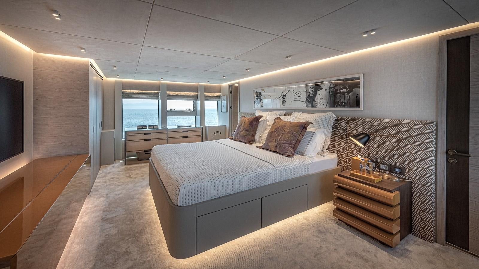 a bedroom with a bed and a dresser aboard 37XP Yacht for Sale