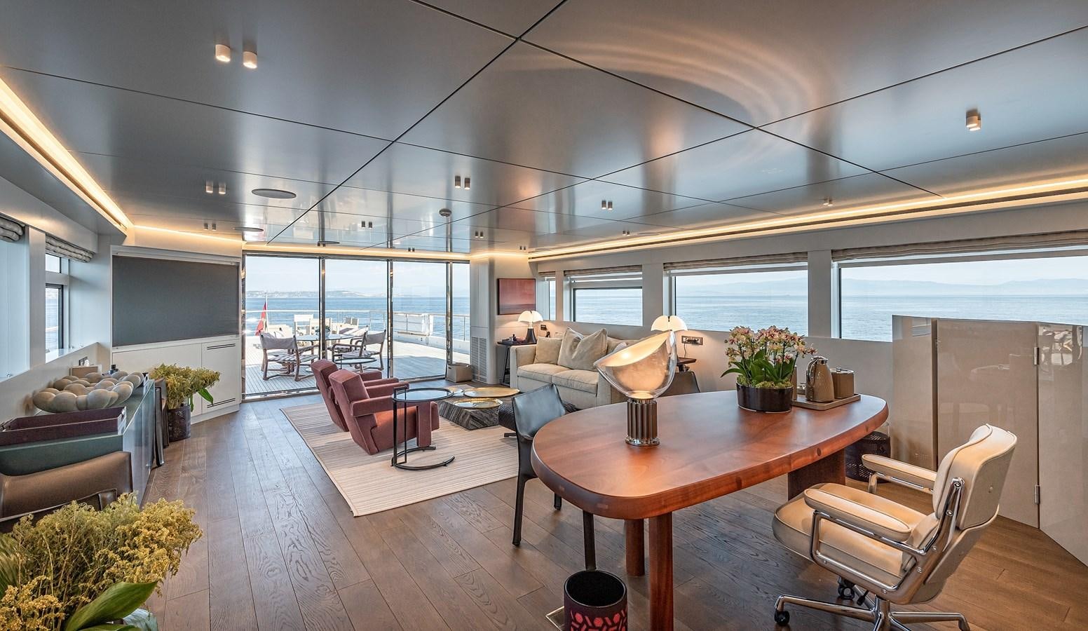 a room with a table chairs and a large window aboard 37XP Yacht for Sale