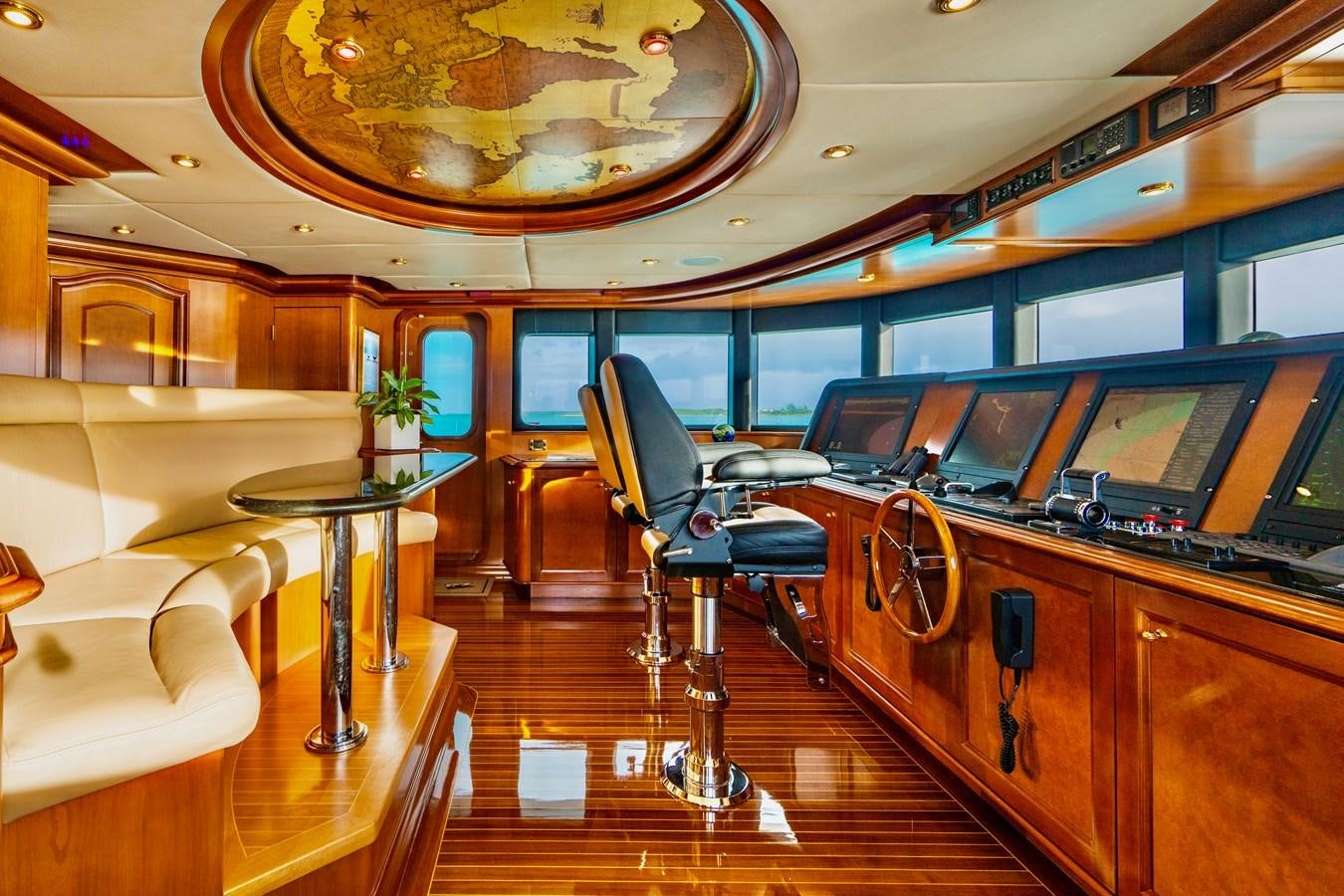 a room with a desk and chairs aboard AQUASITION Yacht for Sale