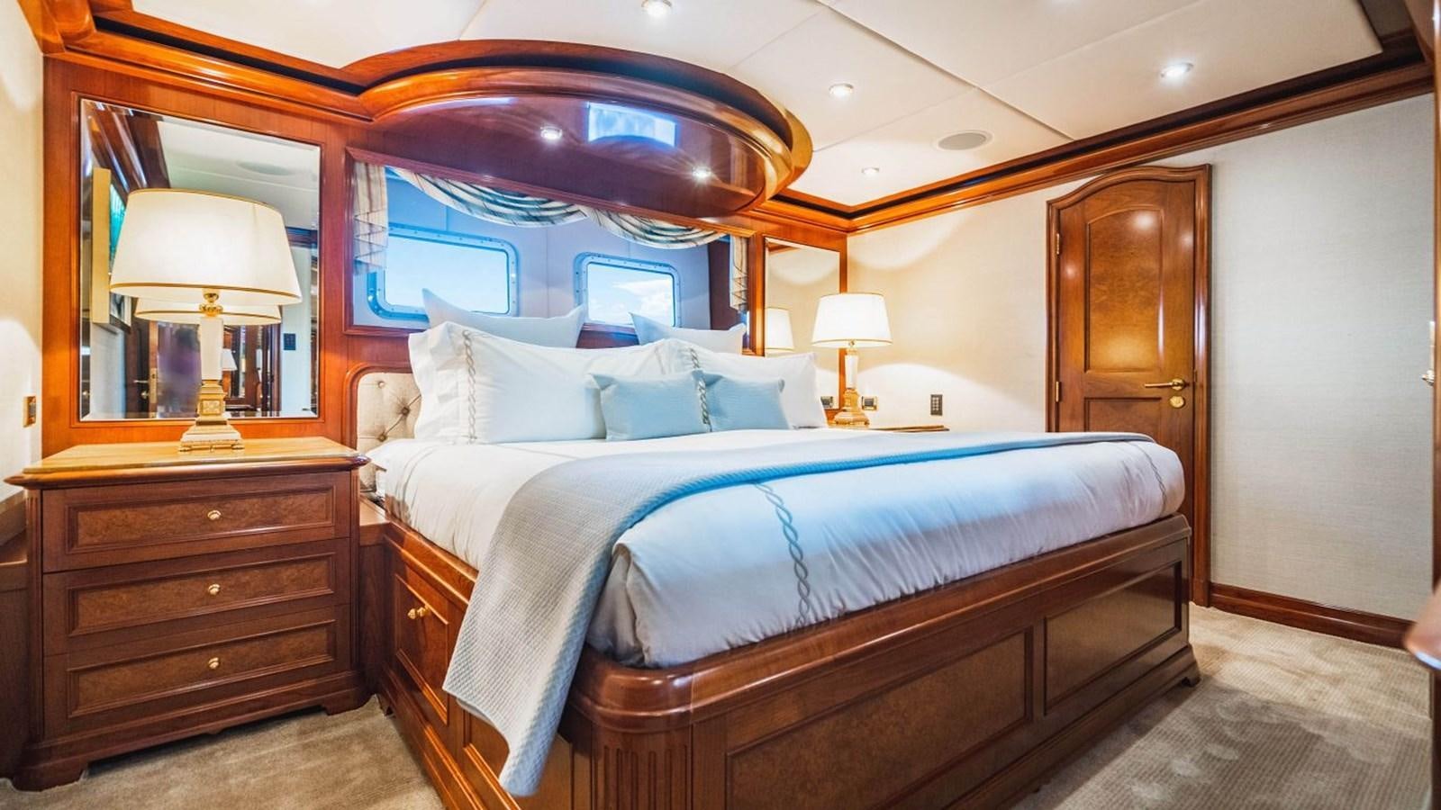 a bedroom with a large mirror aboard AQUASITION Yacht for Sale
