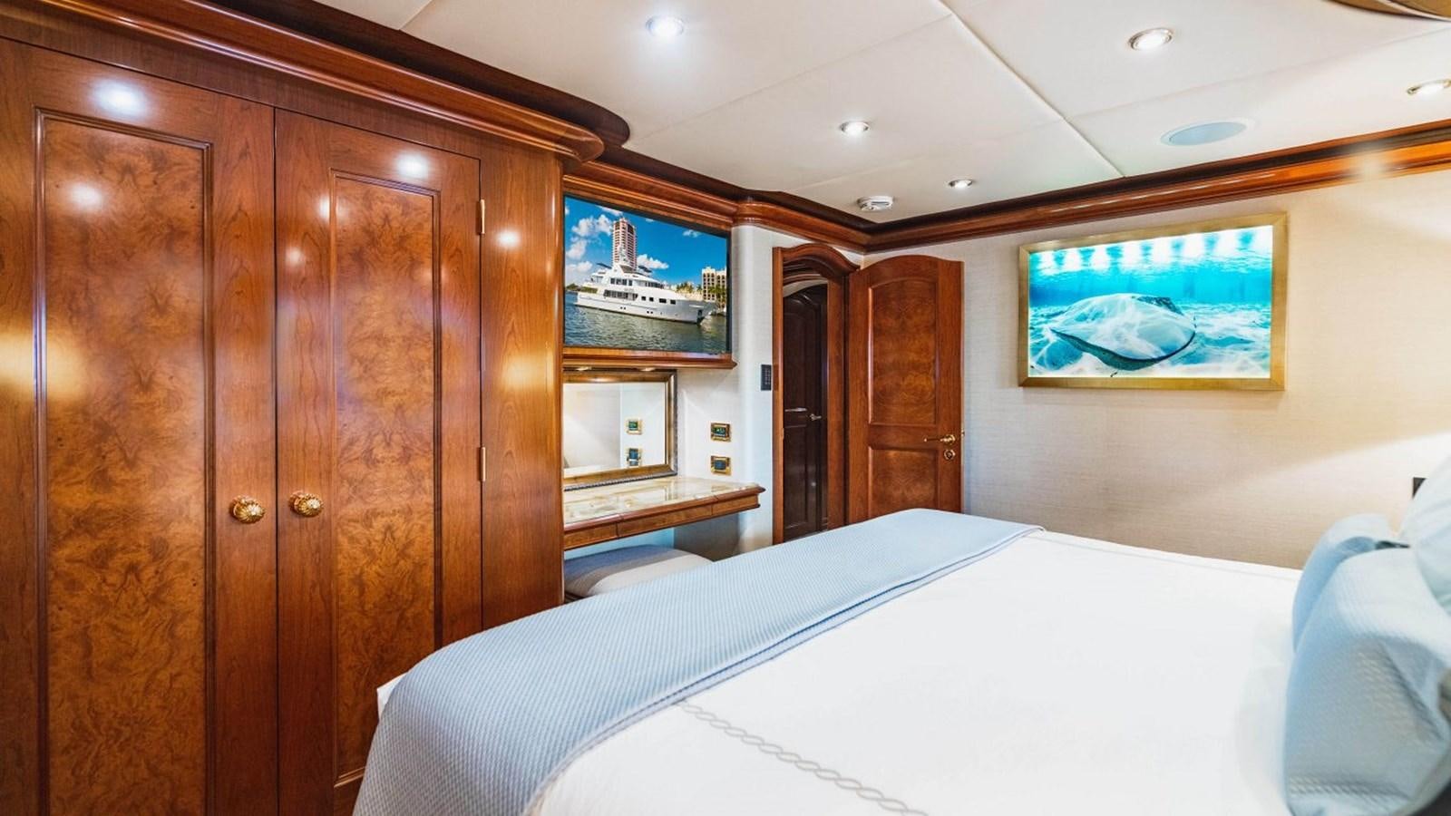 a room with a bed and a wood cabinet aboard AQUASITION Yacht for Sale